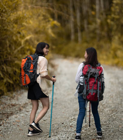 Two female friends enjoy short hiking on during weekend.
