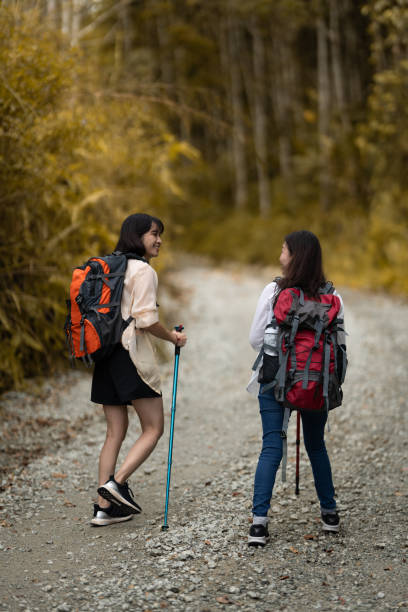 Two female friends enjoy short hiking on during weekend.